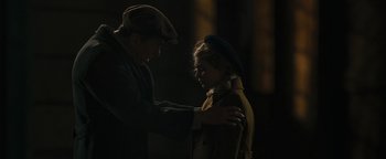 Movie still from “The Book Thief” (2013), directed by Brian Percival – A man and a woman are standing in the dark; Medium shot, Over the shoulder angle