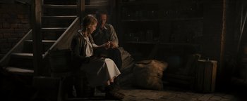 Movie still from “The Book Thief” (2013), directed by Brian Percival – A man and a woman sitting next to each other; Medium shot, High angle