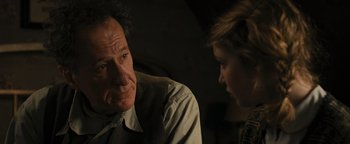 Movie still from “The Book Thief” (2013), directed by Brian Percival – An older man and a young woman are talking; Close Up shot, Over the shoulder angle