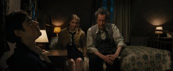 Movie still from “The Book Thief” (2013), directed by Brian Percival – A man and a woman sitting next to each other in a room; Medium shot, Over the shoulder angle