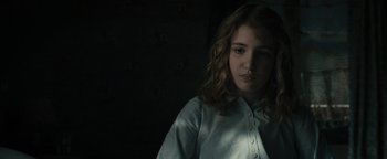 Movie still from “The Book Thief” (2013), directed by Brian Percival – A woman in a white shirt is standing in a dark room; Close Up shot, Low angle
