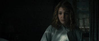 Movie still from “The Book Thief” (2013), directed by Brian Percival – A woman in a white shirt is in a dark room; Close Up shot, High angle