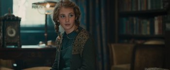 Movie still from “The Book Thief” (2013), directed by Brian Percival – A young girl in a green shirt and a green sweater; Close Up shot, Over the shoulder angle