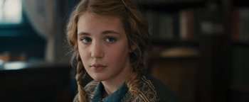 Movie still from “The Book Thief” (2013), directed by Brian Percival – A young girl with long braids looking at the camera; Close Up shot, Over the shoulder angle