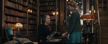 Movie still from “The Book Thief” (2013), directed by Brian Percival – An older woman is holding a book while a younger woman is shaking her hand; Medium shot, Over the shoulder angle
