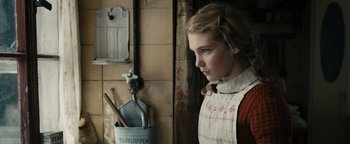 Movie still from “The Book Thief” (2013), directed by Brian Percival – A young girl standing in front of a wall; Close Up shot, Over the shoulder angle