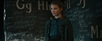 Movie still from “The Book Thief” (2013), directed by Brian Percival – A young girl standing in front of a chalkboard; Medium shot, Over the shoulder angle