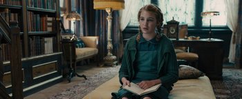 Movie still from “The Book Thief” (2013), directed by Brian Percival – A girl sitting on the floor reading a book; Medium shot, High angle