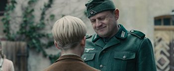 Movie still from “The Book Thief” (2013), directed by Brian Percival – A man in a military uniform talking to a woman; Close Up shot, Over the shoulder angle