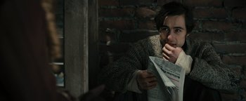 Movie still from “The Book Thief” (2013), directed by Brian Percival – A man holding a newspaper in his hands; Close Up shot, Over the shoulder angle