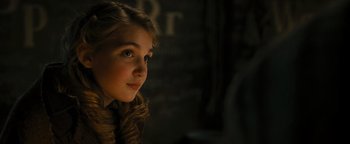 Movie still from “The Book Thief” (2013), directed by Brian Percival – A young girl with long blonde hair looking to her left; Close Up shot, Over the shoulder angle