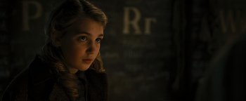 Movie still from “The Book Thief” (2013), directed by Brian Percival – A young girl is standing in front of a brick wall; Close Up shot, High angle