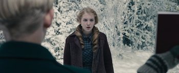Movie still from “The Book Thief” (2013), directed by Brian Percival – A young woman standing in front of snow covered trees; Close Up shot, Over the shoulder angle