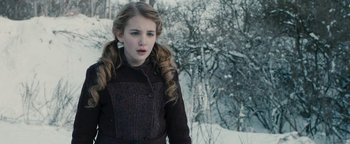 Movie still from “The Book Thief” (2013), directed by Brian Percival – A young girl standing in the snow looking at the camera; Close Up shot, Over the shoulder angle