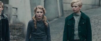 Movie still from “The Book Thief” (2013), directed by Brian Percival – A girl and a boy walking down a street; Medium shot, Over the shoulder angle