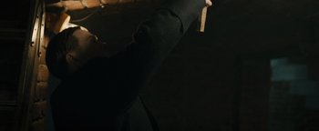 Movie still from “The Book Thief” (2013), directed by Brian Percival – A person is holding something in their hand; Medium shot, Low angle