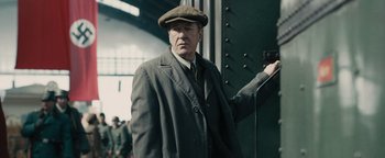 Movie still from “The Book Thief” (2013), directed by Brian Percival – An older man in a hat and a coat; Medium shot, Low angle