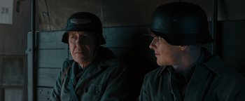 Movie still from “The Book Thief” (2013), directed by Brian Percival – A man and a woman in military uniforms are looking at one another; Close Up shot, Over the shoulder angle