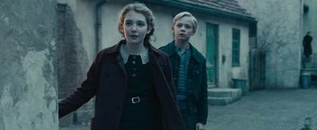 Movie still from “The Book Thief” (2013), directed by Brian Percival – A young girl and a young boy standing next to each other; Medium shot, Over the shoulder angle