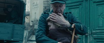 Movie still from “The Book Thief” (2013), directed by Brian Percival – An old man holding a little girl in his arms; Close Up shot, Over the shoulder angle