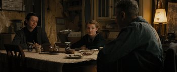 Movie still from “The Book Thief” (2013), directed by Brian Percival – A woman sitting at a dinner table with a man; Medium shot, Over the shoulder angle