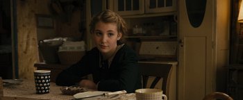 Movie still from “The Book Thief” (2013), directed by Brian Percival – A girl sitting at a table with a plate in front of her; Medium shot, Over the shoulder angle