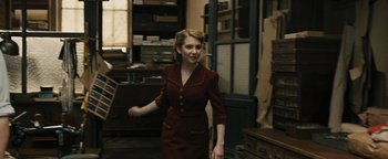 Movie still from “The Book Thief” (2013), directed by Brian Percival – A woman in a red dress is standing in a room; Medium shot, Over the shoulder angle