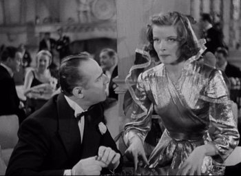 Movie still from “Bringing Up Baby” (1938), directed by Howard Hawks – A man and a woman in formal wear in a room; Medium shot, Over the shoulder angle