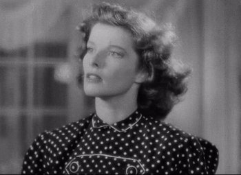 Movie still from “Bringing Up Baby” (1938), directed by Howard Hawks – An old black and white photo of a woman in a polka dot dress; Close Up shot, Low angle