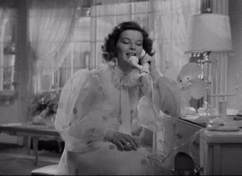 Movie still from “Bringing Up Baby” (1938), directed by Howard Hawks – An old photo of a woman talking on a phone; Medium shot, High angle
