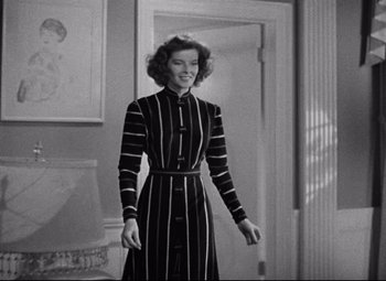 Movie still from “Bringing Up Baby” (1938), directed by Howard Hawks – A black and white photo of a woman in a striped dress; Medium shot, Low angle