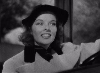 Movie still from “Bringing Up Baby” (1938), directed by Howard Hawks – A black and white photo of a woman wearing a hat; Close Up shot, Low angle