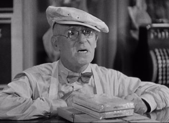 Movie still from “Bringing Up Baby” (1938), directed by Howard Hawks – An older man wearing a hat and glasses; Close Up shot, Low angle