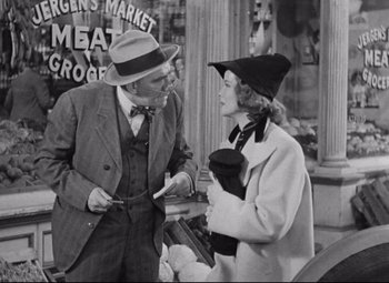 Movie still from “Bringing Up Baby” (1938), directed by Howard Hawks – An old photo of a man and a woman talking to each other; Medium shot, Over the shoulder angle