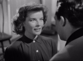 Movie still from “Bringing Up Baby” (1938), directed by Howard Hawks – An old black and white photo of a man and a woman talking; Close Up shot, Over the shoulder angle