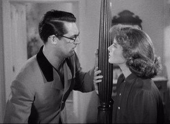 Movie still from “Bringing Up Baby” (1938), directed by Howard Hawks – A man and a woman looking at each other in a room; Medium shot, Over the shoulder angle