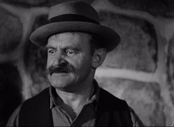 Movie still from “Bringing Up Baby” (1938), directed by Howard Hawks – An older man with a mustache wearing a hat; Close Up shot, High angle