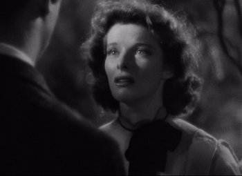 Movie still from “Bringing Up Baby” (1938), directed by Howard Hawks – An old black and white photo of a woman looking at the camera; Close Up shot, Low angle