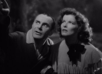 Movie still from “Bringing Up Baby” (1938), directed by Howard Hawks – An older man and a younger woman standing next to each other; Close Up shot, Low angle