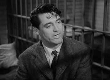 Movie still from “Bringing Up Baby” (1938), directed by Howard Hawks – Black and white photograph of a man wearing a suit and tie; Close Up shot, Over the shoulder angle