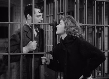 Movie still from “Bringing Up Baby” (1938), directed by Howard Hawks – A man and a woman are standing in a jail cell; Medium shot, Low angle