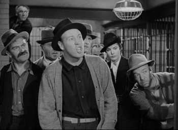 Movie still from “Bringing Up Baby” (1938), directed by Howard Hawks – A group of men standing next to each other in a room; Medium shot, Low angle