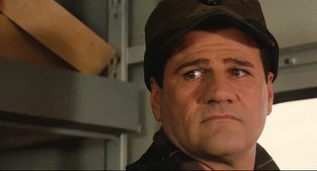 Movie still from “Broadcast News” (1987), directed by James L. Brooks – A person wearing a hat; Close Up shot, Low angle