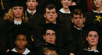 Movie still from “Broadcast News” (1987), directed by James L. Brooks – A group of young men wearing graduation caps and gowns; Close Up shot, High angle