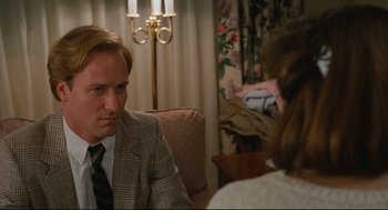 Movie still from “Broadcast News” (1987), directed by James L. Brooks – A man and a woman sitting in a living room; Close Up shot, Over the shoulder angle