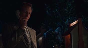 Movie still from “Broadcast News” (1987), directed by James L. Brooks – A man wearing a suit and tie talking on the phone; Close Up shot, Low angle