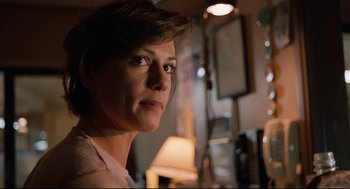 Movie still from “Broadcast News” (1987), directed by James L. Brooks – A person with short brown hair; Close Up shot, Low angle