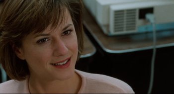 Movie still from “Broadcast News” (1987), directed by James L. Brooks – A person with short brown hair; Close Up shot, Over the shoulder angle
