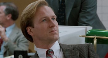 Movie still from “Broadcast News” (1987), directed by James L. Brooks – A person wearing a suit and tie; Close Up shot, Low angle
