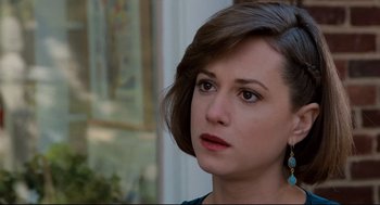 Movie still from “Broadcast News” (1987), directed by James L. Brooks – A person wearing a blue shirt; Close Up shot, Over the shoulder angle